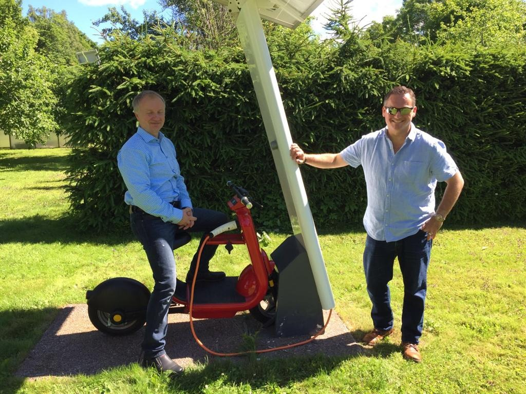 Simon next to E-Roll Scooter at Charger